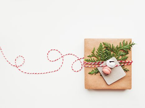 Christmas DIY presents wrapped in craft paper with fir tree branches and red hearts. Top view on decorations on New Year gifts. Festive background. Winter holiday spirit. Banner with copy space.