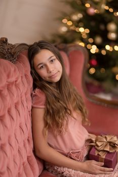 gorgeous girl with a holiday christmas present in a stylish interior.