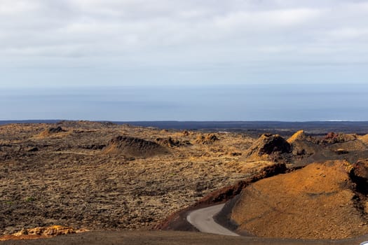 View at multi colored volcanic landscape in Timanfaya Nationalpark on canary island Lanzarote, Spain 