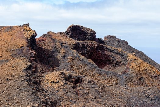 View at multi colored volcanic landscape in Timanfaya Nationalpark on canary island Lanzarote, Spain 