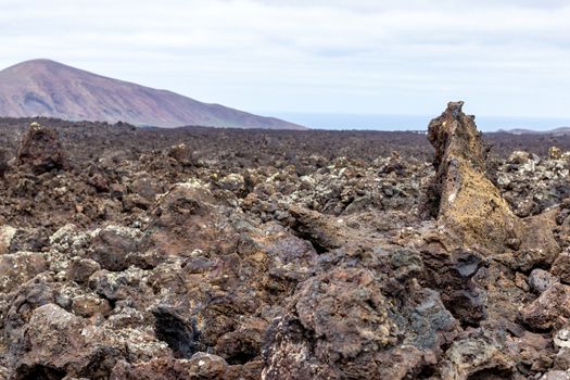 View at multi colored volcanic landscape in Timanfaya Nationalpark on canary island Lanzarote, Spain 