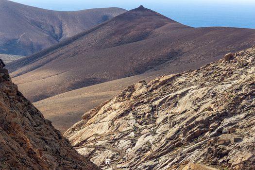 Panoramic view at landscape between Betancuria and Pajara  on Fuerteventura, Spain with multi colored volcanic mountains