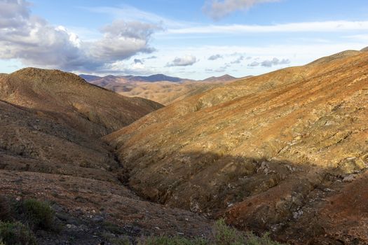 Panoramic view at landscape between Betancuria and Pajara  on Fuerteventura, Spain with multi colored volcanic hills and mountains