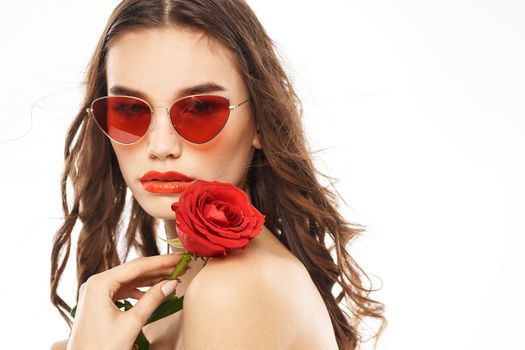 Brunette girl with red rose and sunglasses naked shoulders. High quality photo