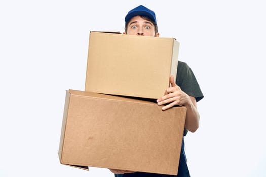 Working man with boxes in hands delivery service work lifestyle. High quality photo