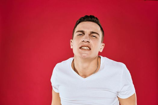 Man in white t-shirt emotions displeased facial expression isolated background. High quality photo