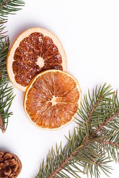 Christmas composition with dried citrus slices, pine cones and fir tree branches, top view