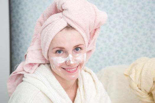 Portrait of woman doing doing spa treatments in the bedroom.