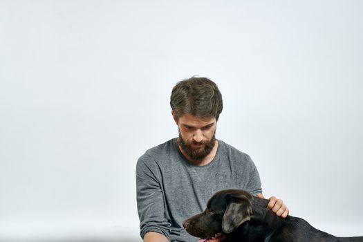 happy owner with pet black dog training model emotions. High quality photo