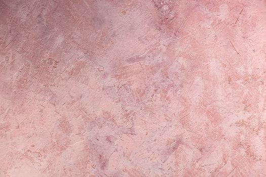 Concrete pink background with scuffs and splashes. Textured wall texture in the grunge style with soft focus. Space for text