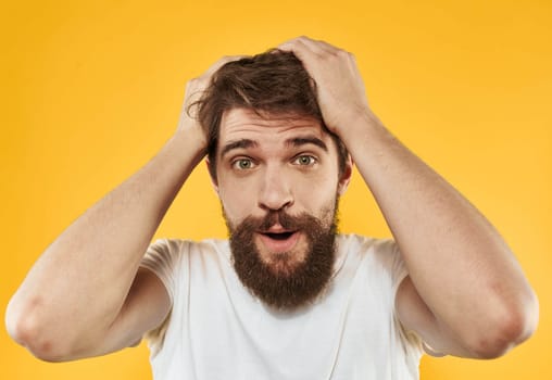 portrait of a man white t-shirt yellow background cropped view Copy Space. High quality photo