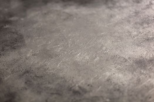 Concrete dark gray background with scuffs and splashes. Textured wall texture in the grunge style with soft focus. Space for text