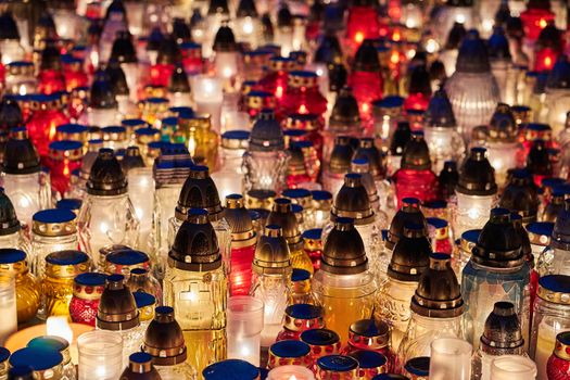 Candles burning on a grave in the cemetery of All Saints' Day in Poland