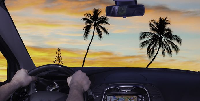 Driving a car towards a tropical sunset in Moorea, French Polynesia