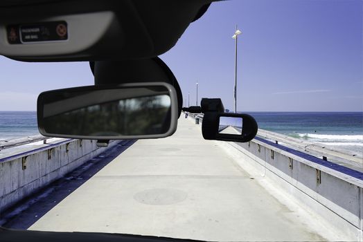 Looking through a dashcam car camera installed on a windshield with view of Venice Beach Pier, Los Angeles, California, USA