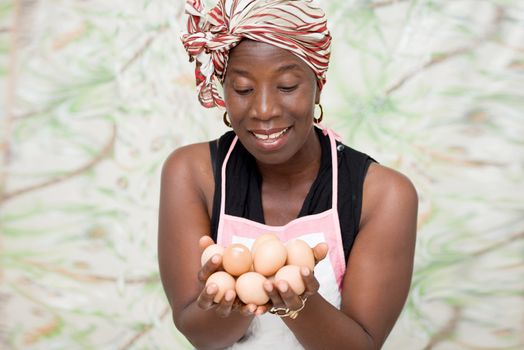 young smiling woman holding eggs in her hands
