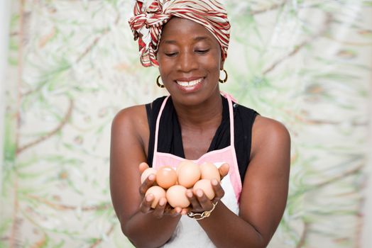 young smiling woman holding eggs in her hands