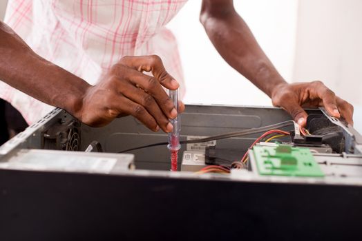Close up of hands of a computer expert repairing a computer inside