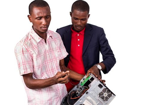 Technician repairing a computer in an office in front of his boss