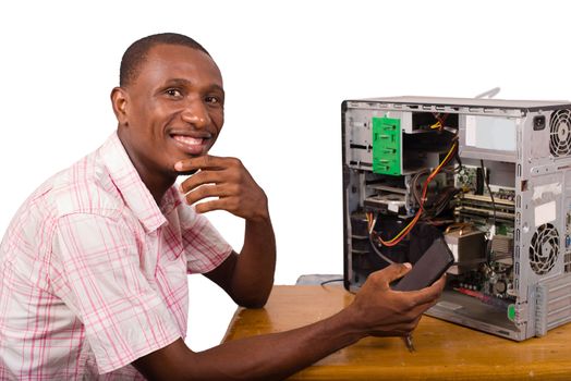 young smiling african worker in service repairing a computer and holding a mobile phone