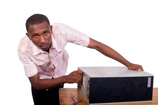 computer support engineer unscrewing a computer. Isolated on a white background