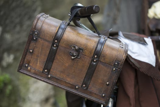 Old wooden chest hanging at the handlebar of a bicycle