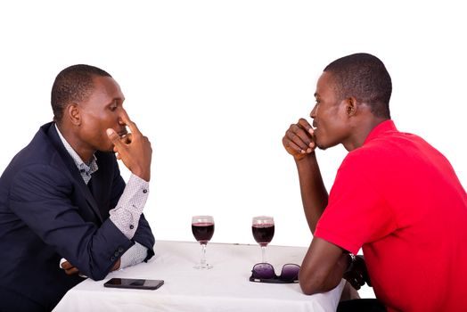 Group of happy people drink wine at the table and discuss together about their business,