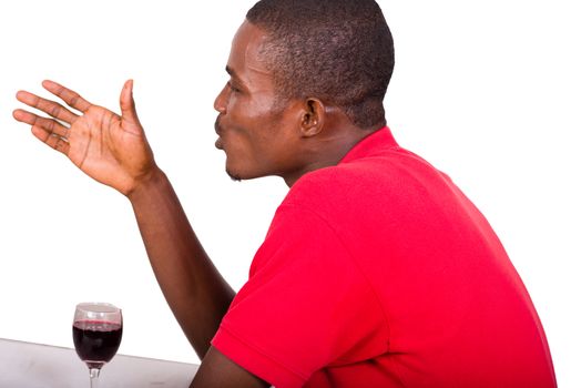 young men sitting at the restaurant in front of a glass of wine and talking alone