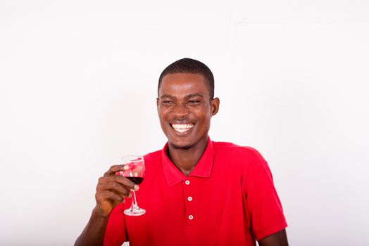 portrait of happy young standing man holding a glass of red wine isolated on a white background.