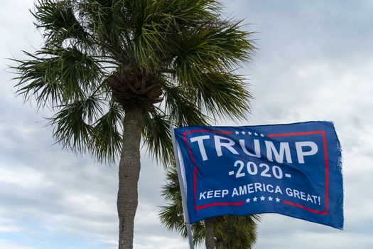 October 22, 2020 - Tarpon Springs, Florida, USA: A Trump supporter flies a flag at a local beach in Tarpon Springs, Florida