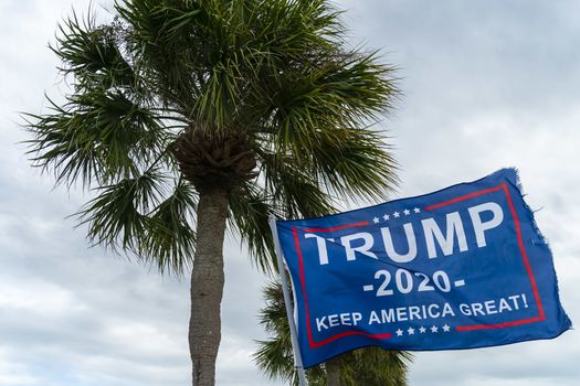 October 22, 2020 - Tarpon Springs, Florida, USA: A Trump supporter flies a flag at a local beach in Tarpon Springs, Florida