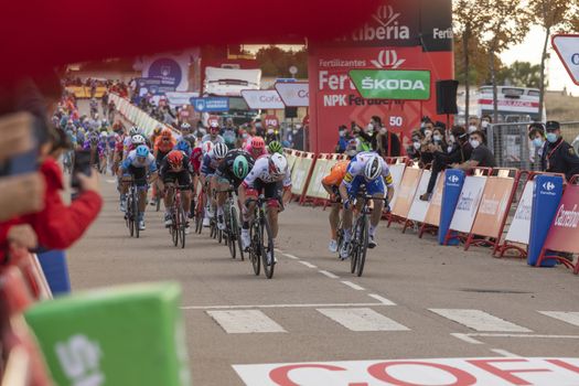 Cyclists from different teams, pedaling hard in the final sprint, in the area of the finish line of the fourth stage of La Vuelta a España 2020.