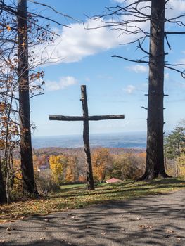 Simple wooden cross or crucifix overlooking the autumn landscape near Uniontown in Pennsylvania