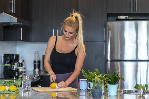 A gorgeous blonde model prepares a meal before heading to work