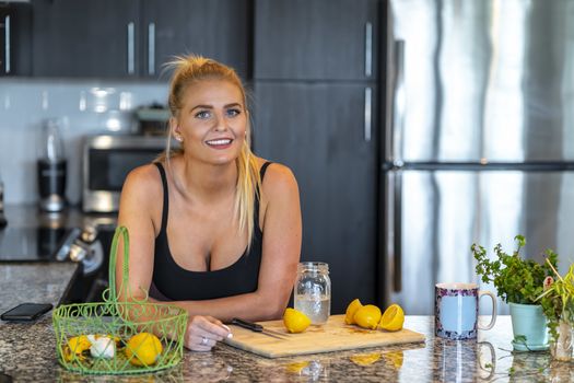 A gorgeous blonde model prepares a meal before heading to work