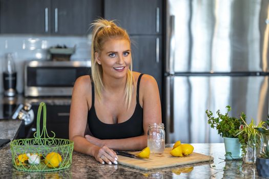 A gorgeous blonde model prepares a meal before heading to work