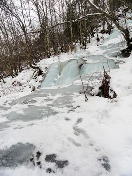 Frozen waterfall and icicles in a beautiful landscape in Norway.