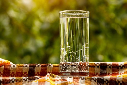 A glass of water in the garden background