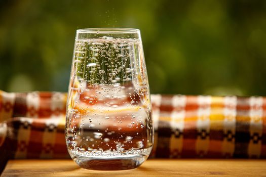 A glass of water in the garden background