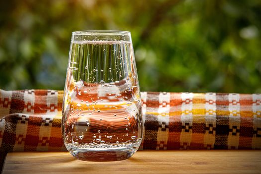 A glass of water in the garden background