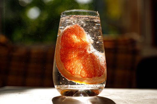 A glass of water with grapefruit