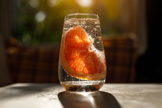 A glass of water with grapefruit