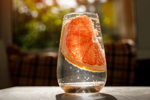 A glass of water with grapefruit