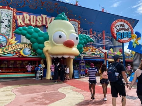 Orlando, FL/USA - 10/18/20:  The entrance to The Simpsons Ride at Universal Studios in Orlando, Florida with people wearing face masks and social distancing.