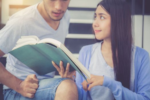 Closeup couple asian handsome man and beautiful woman reading book and glad at home, boyfriend and girlfriend with activities together for leisure, education success concept.