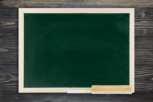 Blackboard with wooden frame, blackboard on old wood background for education concept.