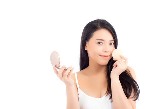 Portrait of beautiful asian woman applying powder puff at cheek makeup of cosmetic, beauty of girl with face smile isolated on white background, wellness and healthcare concept.