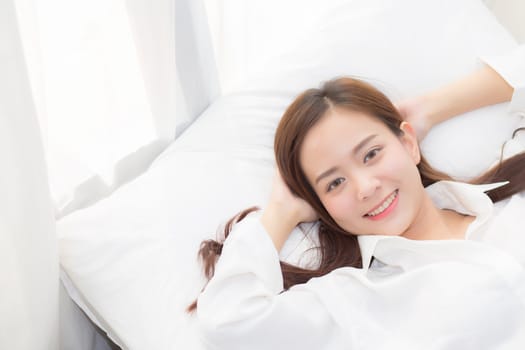Beautiful asian young woman sleeping lying in bed with head on pillow comfortable and happy. girl with relax for health concept.