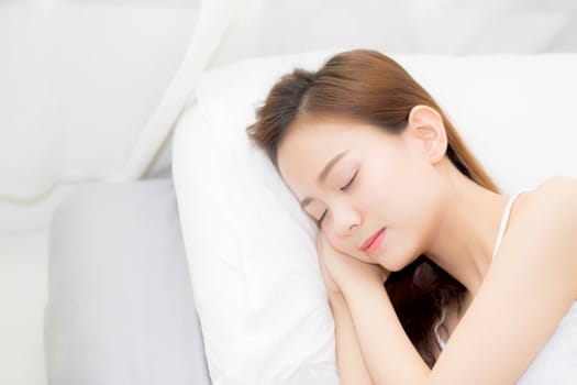Beautiful asian young woman sleeping lying in bed with head on pillow comfortable and happy. girl with relax for health concept.