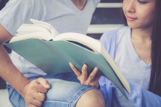 Closeup couple asian handsome man and beautiful woman reading book and glad at home, boyfriend and girlfriend with activities together for leisure, education success concept.